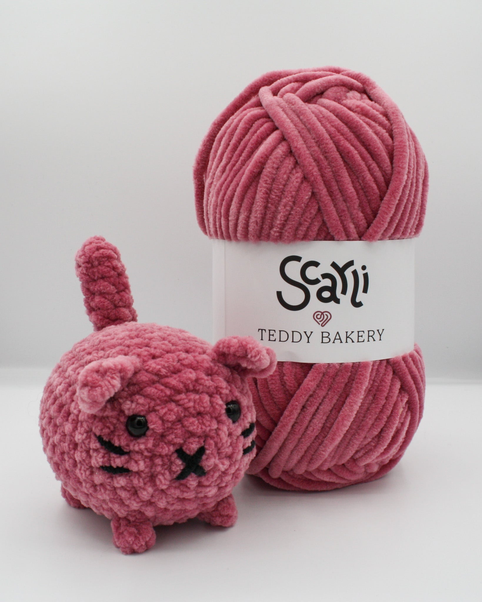 skein of rose chenille plush yarn with amigurumi crochet cat plushie pink