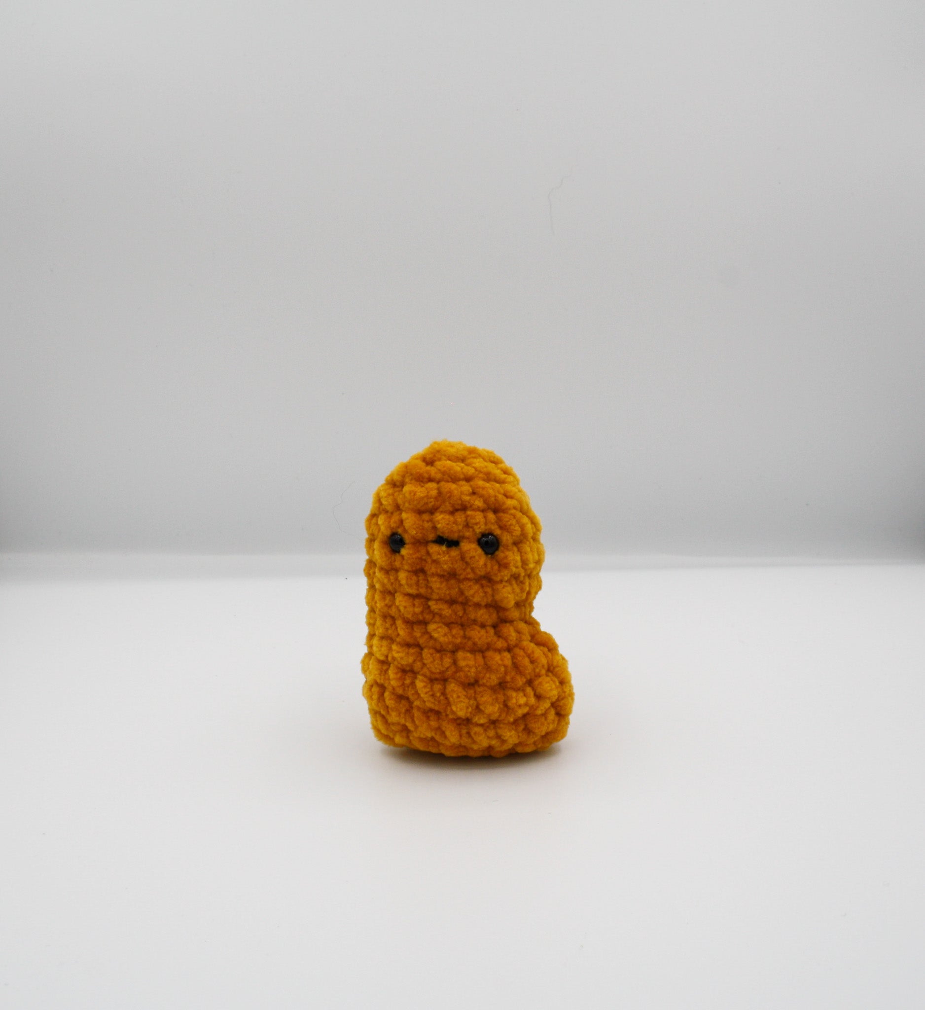 amigurumi crochet nugget plushie made with golden chenille yarn