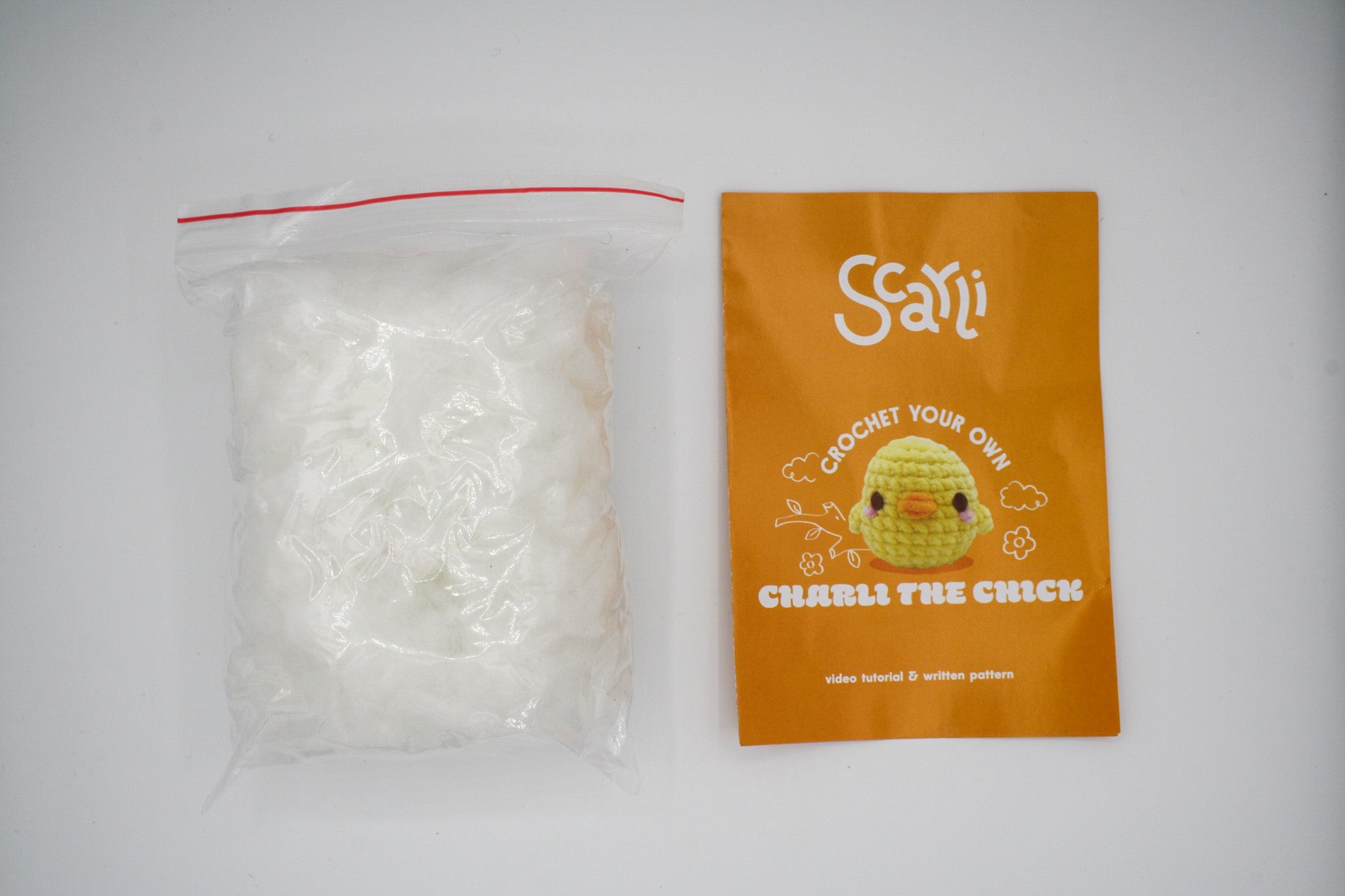 beginner crochet kit charli the chick pamphlet with written and video tutorials, and stuffing.