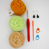 beginner crochet kit toby the turtle materials including training yarn, chenille yarn for turtle, stitch markers, darning needle, safety eyes, and crochet hook.