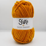 dark golden orange skein of chenille plush yarn called Teddy Bakery