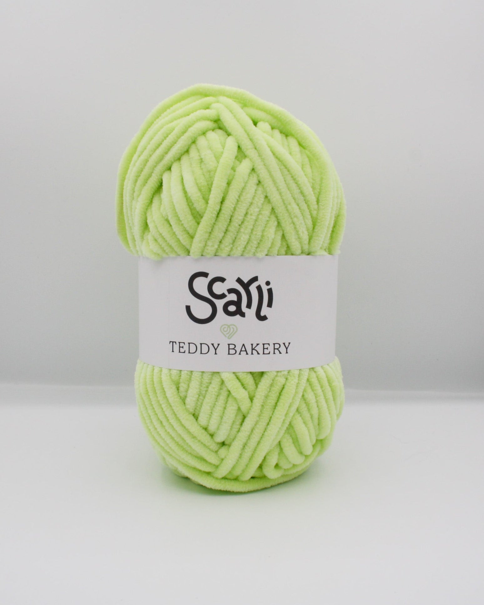 skein of lime green chenille plush yarn scarli teddy bakery