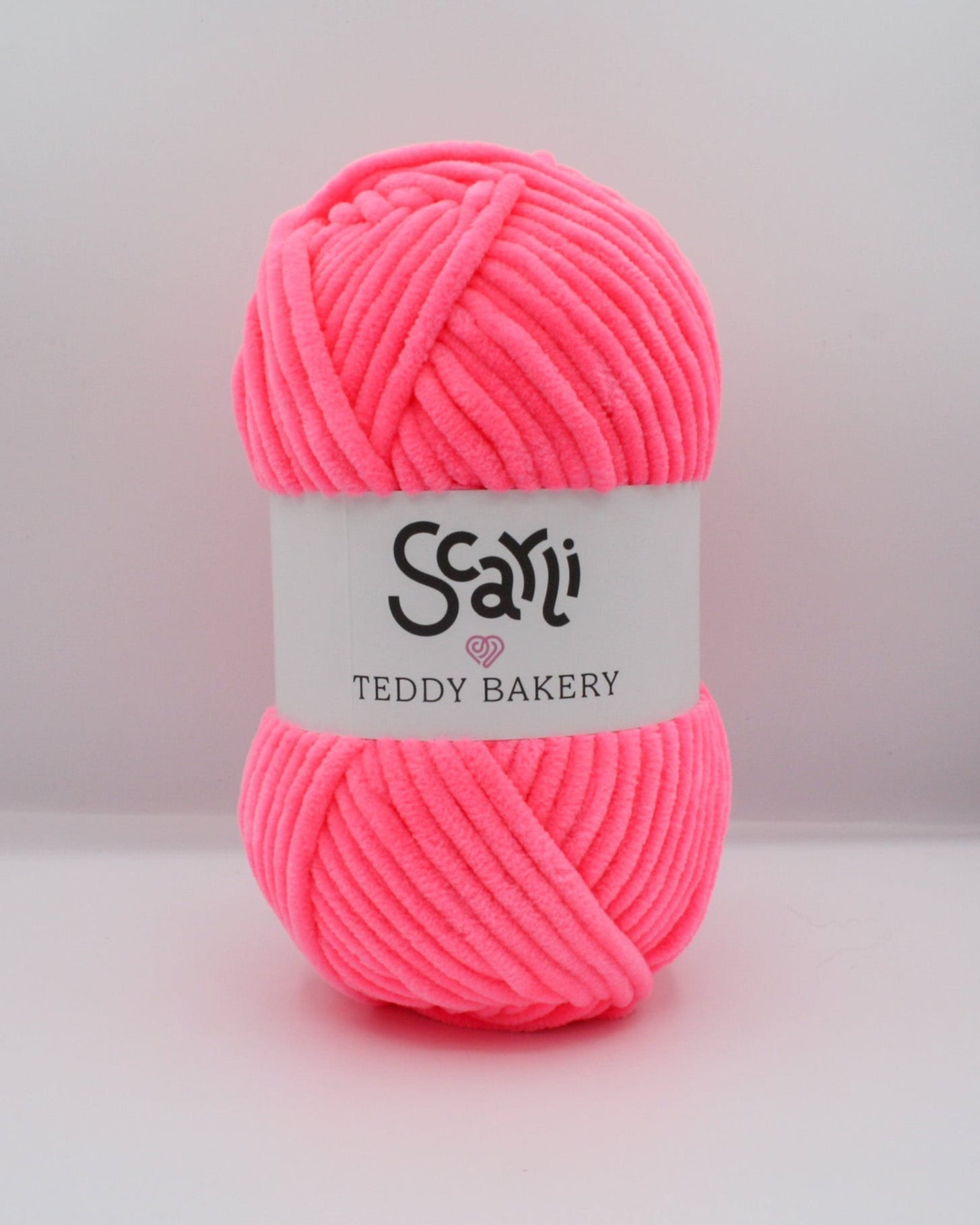 neon pink skein of chenille plush yarn scarli teddy bakery strawberry