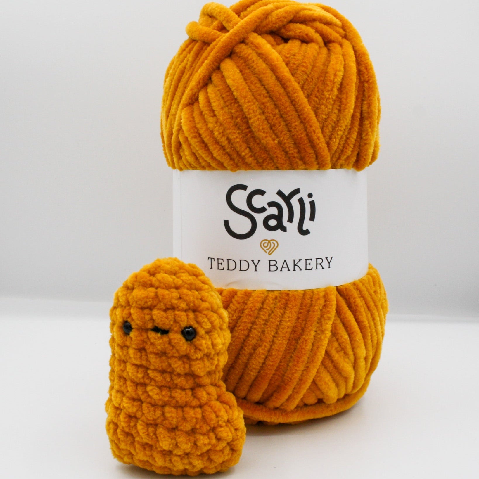 burnt orange golden yellow skein of chenille plush yarn Teddy Bakery with nugget amigurumi crochet plushie