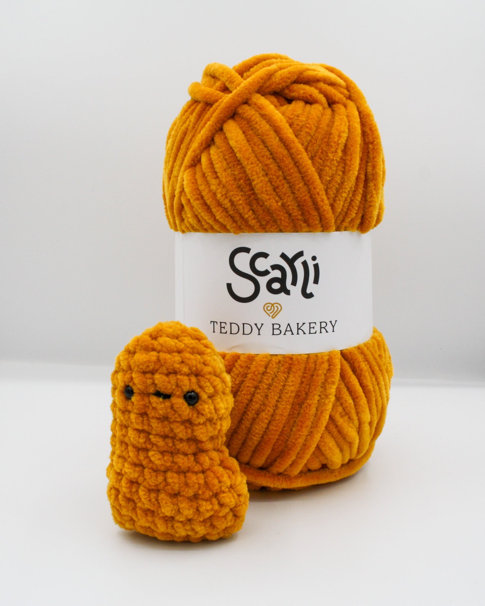 burnt orange golden yellow skein of chenille plush yarn Teddy Bakery with nugget amigurumi crochet plushie