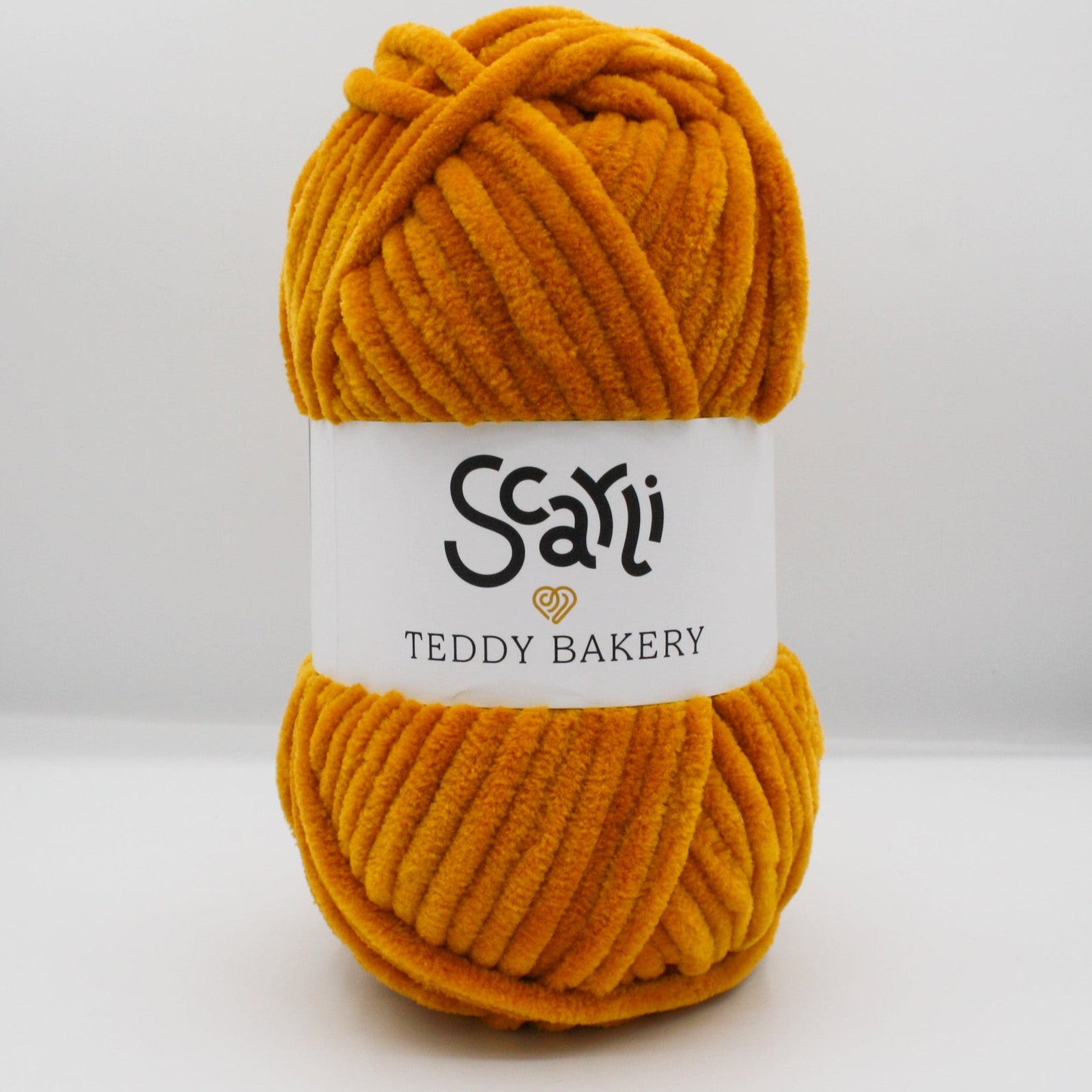 dark golden orange skein of chenille plush yarn called Teddy Bakery