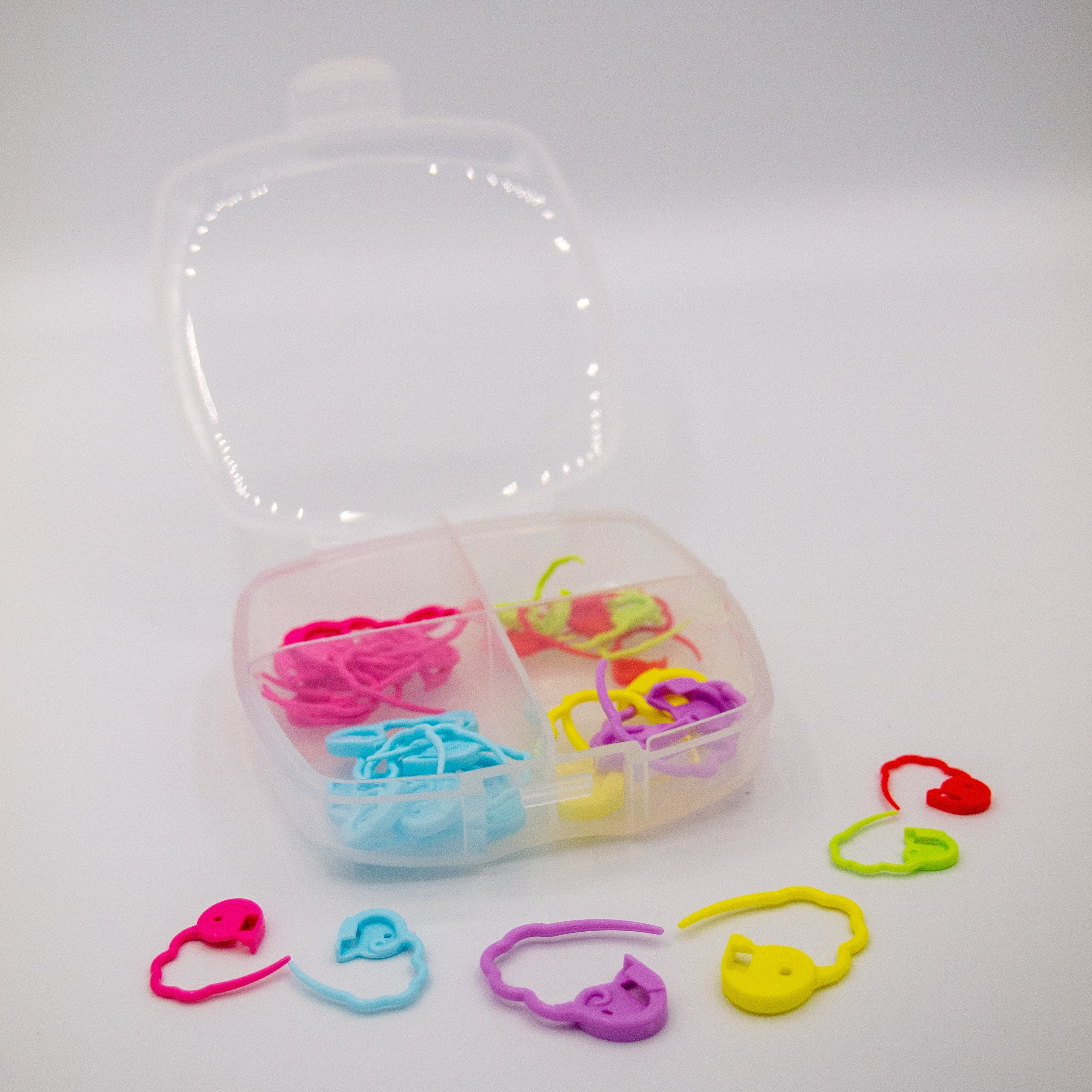 clover quick locking stitch markers. Small, medium and large size4d plastic stitch markers for crochet and knitting. Colours pink, green, blue, red, purple and yellow. Includes box for storage