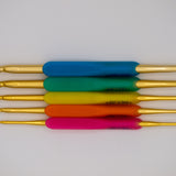 Hamanaka crochet hook set. Includes five hooks with 10 hook sizes including 2mm, 2.2mm, 2.5mm, 3mm, 3.5mm, 4mm, 4.5mm, 5mm, 5.5mm, 6mm. Gold aluminium hook with plastic ergonomic handle in blue, green, yellow, orange and pink