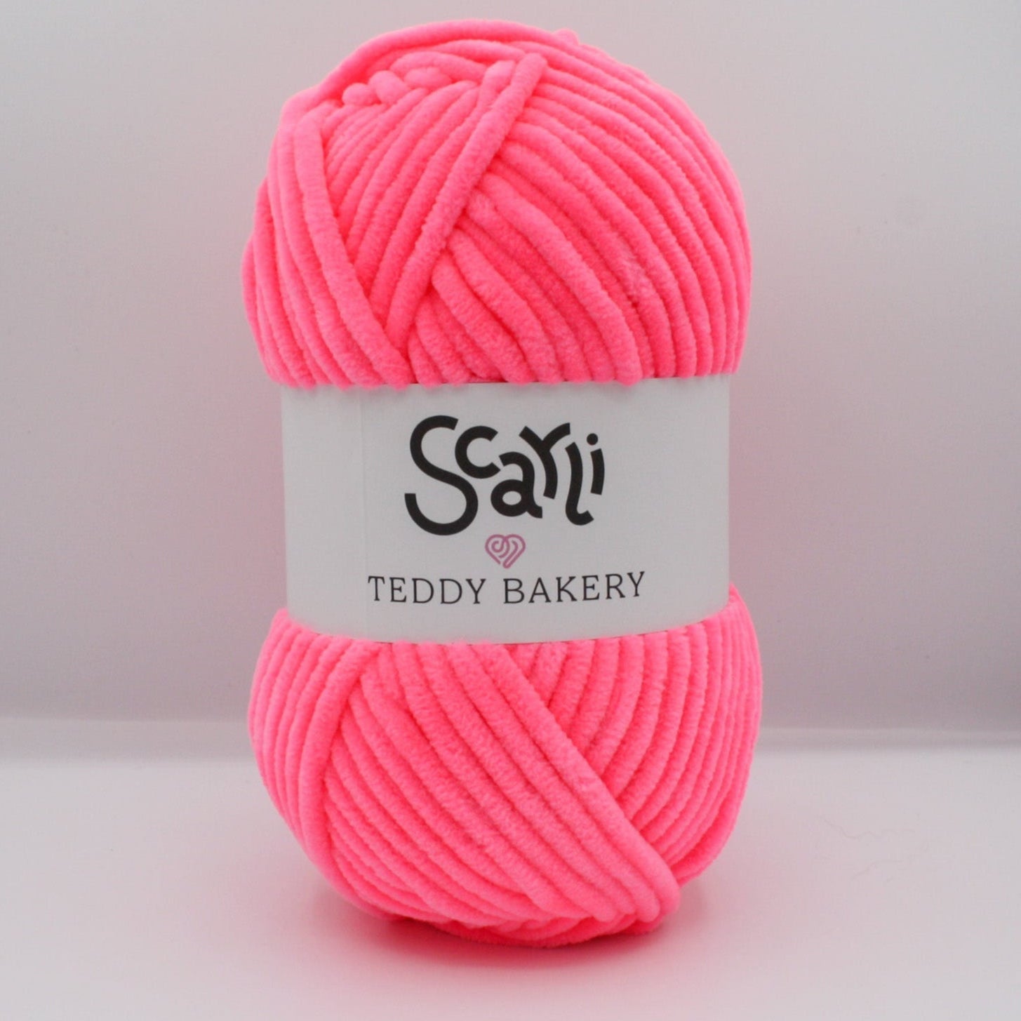 neon pink skein of chenille plush yarn scarli teddy bakery strawberry